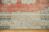 Vintage Oushak rug's intricate, muted multi-banded border and abrash brick orange red field.