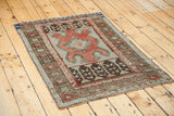 Muted terracotta, brown, and grey geometric tribal patterns on vintage Oushak corner.