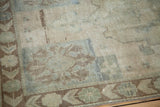 Vintage Oushak rug corner showing decorative patterns in bronze, beige, and silver-blue.