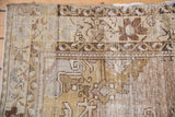 Worn texture and muted patterns on a vintage distressed Oushak rug.