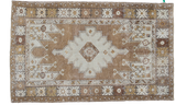 Distressed Turkish Oushak rug with a geometric medallion in pale silver, bronze, and earth tones.