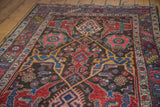 Intricate gerus design on this antique Persian Bidjar rug, featuring ruby red and sapphire blue.