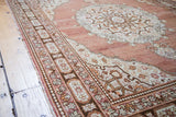 Traditional Persian Tabriz rug with ornate pearl border, floral cartouches, and cinnabar red field.