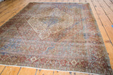 Distressed antique Senneh rug corner showcasing soft royal blue, red-rust tones and fringe.