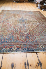 Distressed antique Senneh rug detail, showcasing overdyed royal blue, red rust, and aqua motifs.