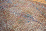 Vibrant blue and aqua tones amidst the distressed red rust of an antique Senneh rug.