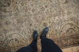 Distressed Mahal carpet's worn texture and faded large-scale pattern.