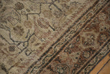 Worn texture and muted earthy brown curvilinear pattern on this distressed vintage Mahal rug.