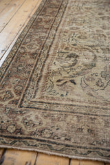 Worn aesthetic and faded patterns on a distressed vintage Mahal carpet.