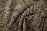 Folds of distressed Persian Mahal carpet, showcasing faded earthy tones and worn texture.