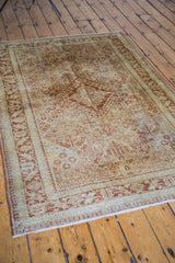 Worn Joshegan rug pile with golden ivory and orange rust four seasons garden pattern.