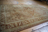 Vintage Joshegan rug border with worn golden ivory texture and classic orange rust patterns.
