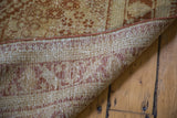 Vintage Joshegan rug's tightly woven foundation, featuring geometric patterns in reddish-brown and tan.
