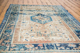 Vintage Karaja rug detail: geometric navy and aqua border on ivory field.