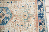 Detail of Karaja rug: ivory field with geometric patterns, aqua blue, navy, and peach tones.