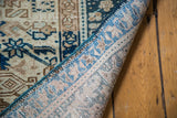 Karaja rug corner revealing hand-knotted back, tightly woven blue and ivory geometric patterns.
