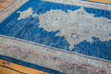 Distressed indigo blue pile and worn light patterns on a Persian Mahal rug.