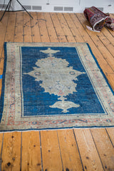 Antique Mahal rug with distinct distressed character and indigo blue medallion.