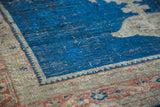 Distressed indigo blue field and worn beige border detail of an Antique Mahal rug.