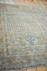 Blossoming tree design with green planters, subtle blue accents, and scrolling arabesque border.