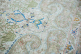Flowing arabesque and meandering leaf motifs in soft blue, green, and pink on this vintage Sivas rug.