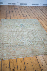 Subtle blue and bronze hues accenting scrolling arabesques and meandering leaf borders.