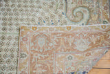 Vintage Sivas rug detail showing delicate thousand flower field and peach-bronze arabesque border.
