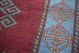 Luxurious deep red field and soft light blue geometric border.