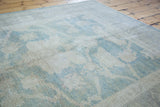 Vintage Oushak carpet's textured pile with aqua seafoam large-scale motifs.