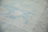 Soft pile of vintage Oushak carpet, featuring subtle aqua, wheat, and beige colors.