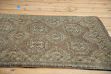 Angled view of Vintage Turkmen rug, highlighting bronze geometric gul motifs and border.