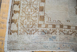 Distressed Oushak rug corner with soft overdye aesthetic, light blue, bronze patterns, and abrashes.