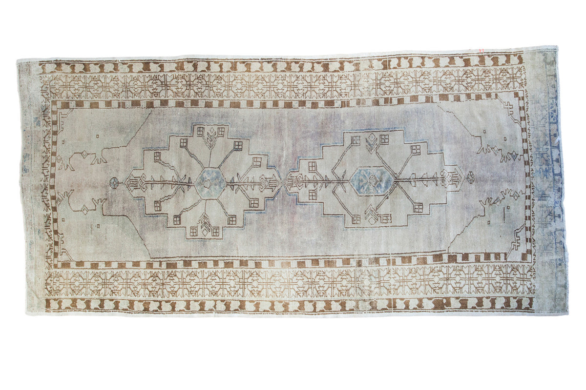 Distressed Oushak runner rug, soft mauve ivory field, blue double medallions, bronze accents. 4'8" x 9'8".