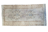 Distressed Oushak runner rug, soft mauve ivory field, blue double medallions, bronze accents. 4'8