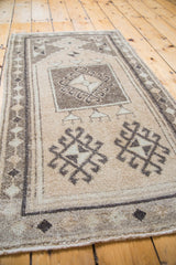 Vintage Oushak rug detail with geometric prayer design motifs in beige, grey, and silver.