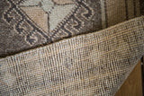 Hand-knotted pile, geometric pattern, and woven foundation of a vintage Oushak rug.