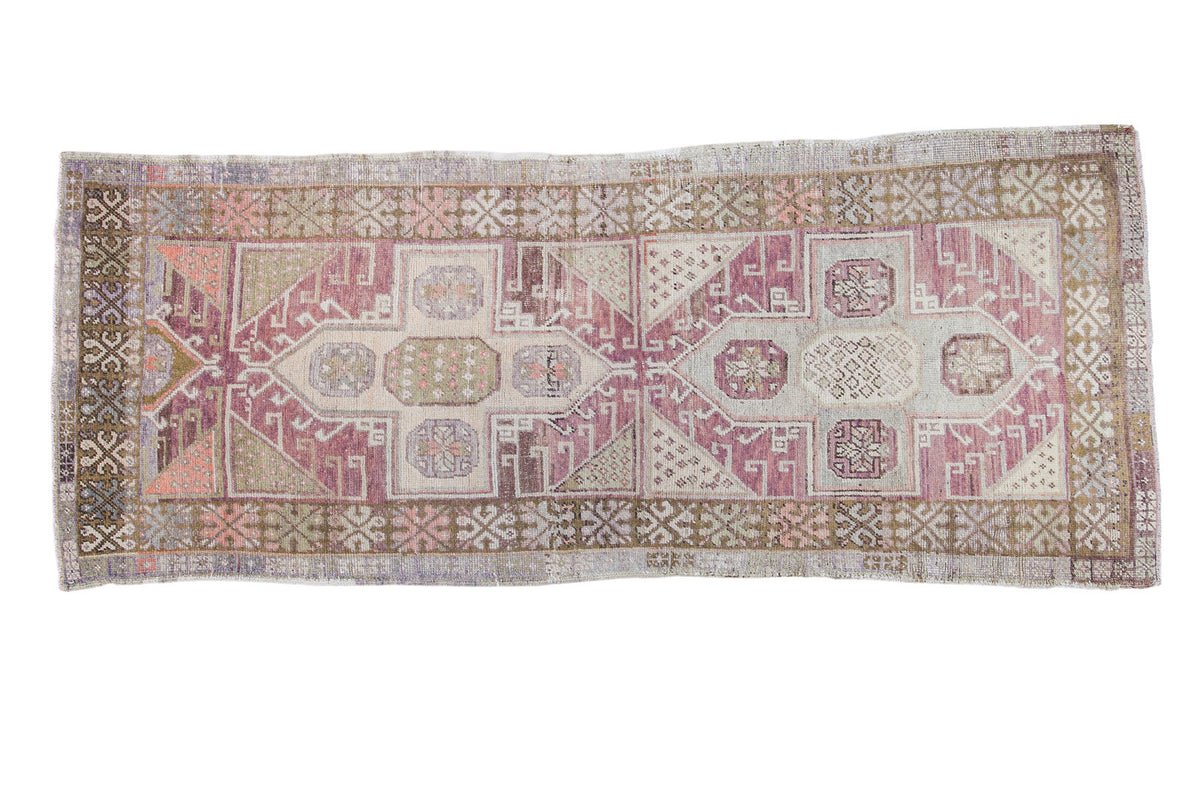 Distressed Oushak rug runner with geometric motif in plum, mauve, bronze, and ivory, 3'8" x 9'2".