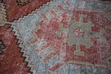 Distressed Oushak rug with rustic geometric patterns in brick red and silvery platinum.