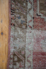 Distressed Oushak runner edge, showing worn geometric texture and brick red selvedge.