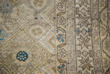 Intricate beige, gold, aqua Herati design detail on vintage Malayer rug.