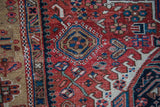 Unusual beige border with geometric plants and gem-tone blues on antique Karaja rug.