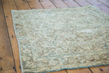 Close-up of vintage Sivas rug border, floral motif in gold, ivory, bronze, charcoal.