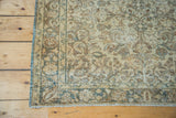 Corner of hand-knotted vintage Sivas rug showing floral motif in gold, ivory, and charcoal.