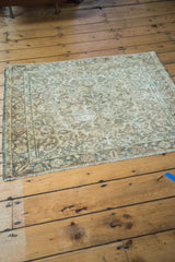 Vintage Sivas rug corner detailing floral motif in gold, ivory, bronze, and charcoal.