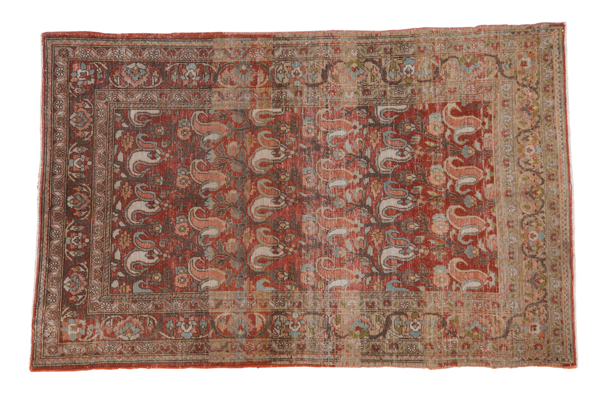 Distressed vintage Persian Birjand rug, faded red rust field with repeating paisley boteh motifs. 3'5" x 5'5".