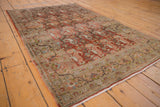 Faded red-rust field, soft peach paisley, and intricate beige border on vintage Birjand rug.