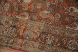 Traditional patterned border and worn texture of the distressed vintage Birjand rug.