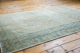 Vintage Afshar rug with geometric boteh motifs in muted aqua, beige, and tan.