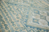 Vintage Afshar carpet with aqua geometric motifs and repeating boteh patterns on beige.