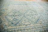 Vintage Afshar carpet with repeating geometric patterns in aqua, tan, and ivory tones.